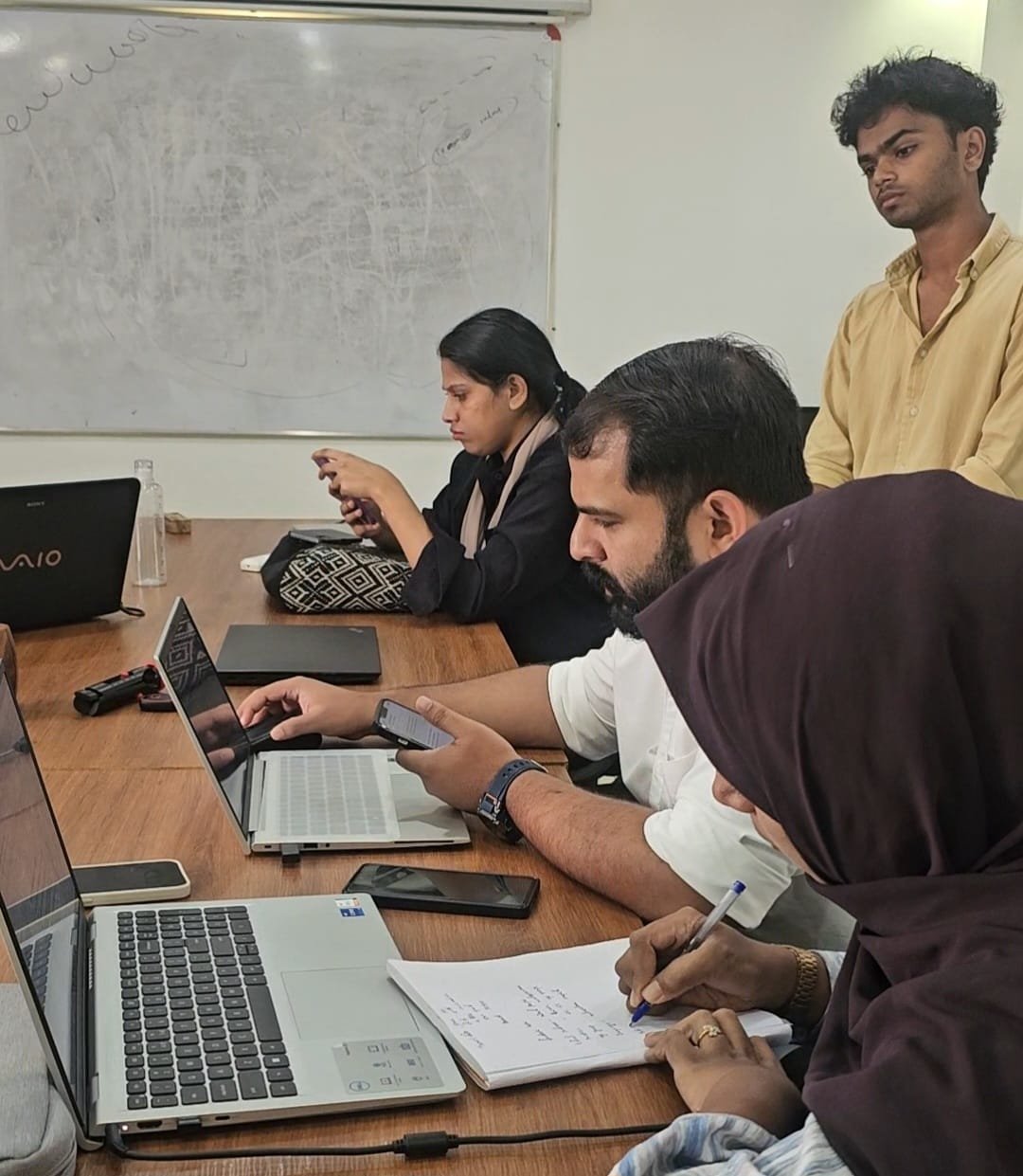 Internet Marketing Academy students discussing digital marketing strategies during live practical training